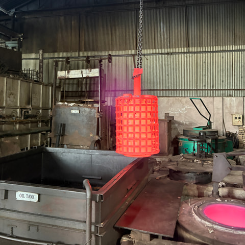 A glowing charge lifted from the furnace above the quench tank